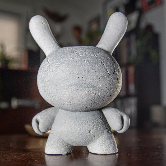 Kidrobot RAW 8-inch Concrete Dunny figure, limited edition collectible toy with a rugged concrete texture and detailed design.