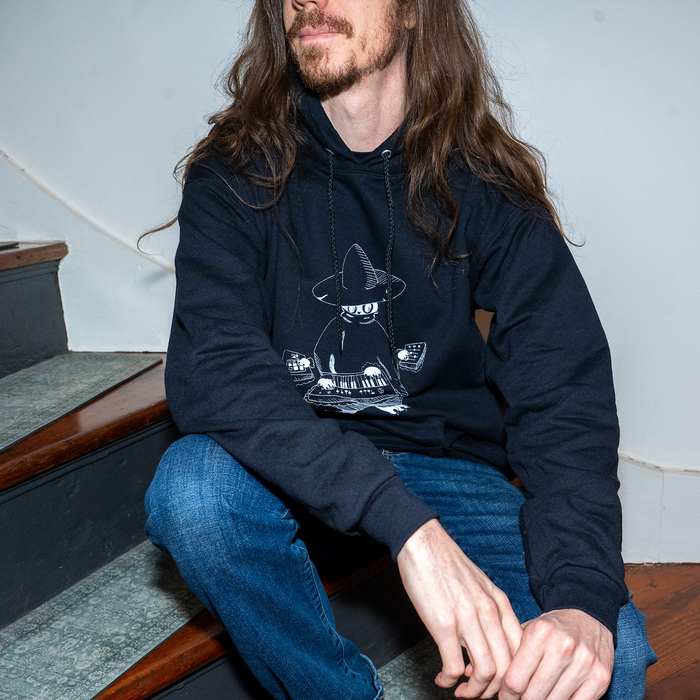 Model wearing Maestro (keys wizard) graphic hoodie from Cryptid Records in black