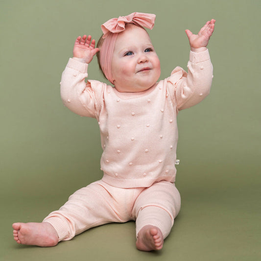 Milan Knit Baby Ruffle & Bobble Pullover Sweater Model Pose (Organic Cotton)