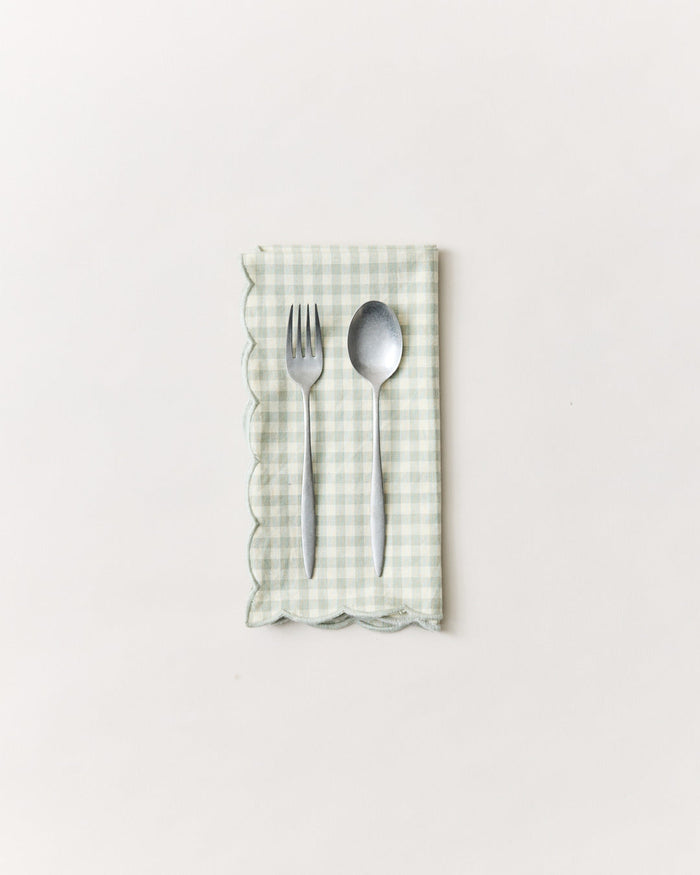 Petite Gingham Scalloped Cotton Napkins — folded Celadon napkin with teaspoons; Farmhouse Pottery