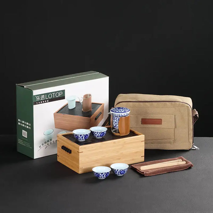 Portable Chinese gongfu tea set with bamboo tray, blue and white cups, carry bag, and tools