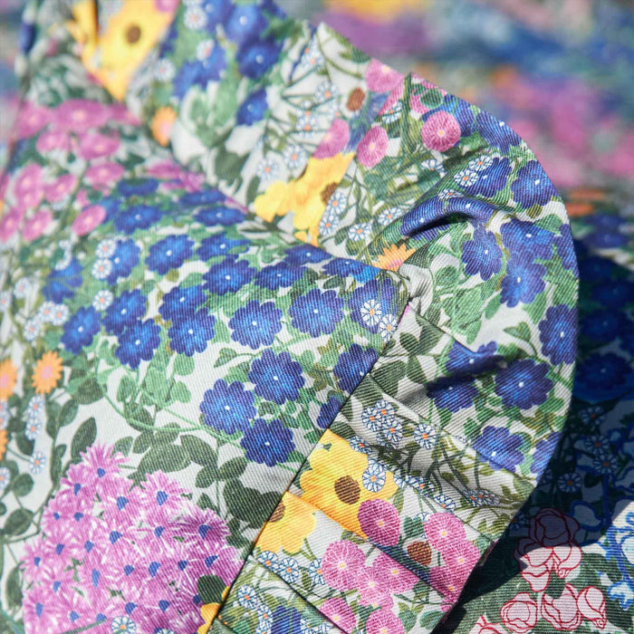 Close-up of the fabric and print on the Pré Fleuri Organic Cotton Ruffled Pillow Cover