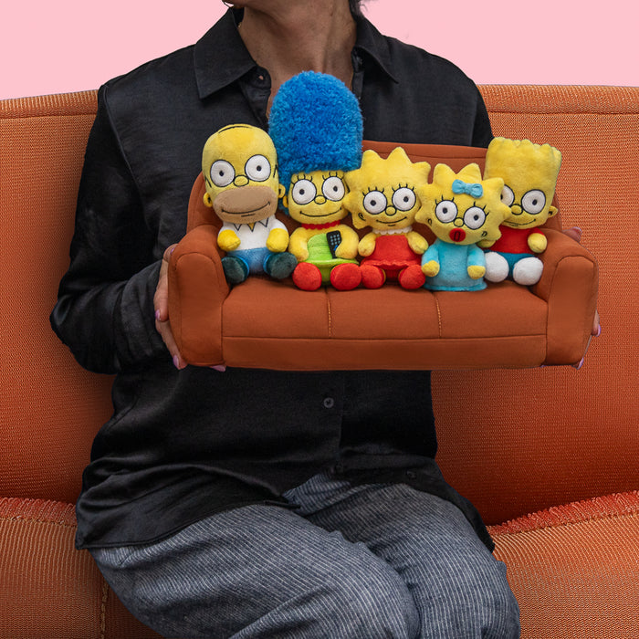 The Simpsons plush family set featuring Homer, Marge, Bart, Lisa, and Maggie sitting on a couch, interactive medium plush toys by The Simpsons.