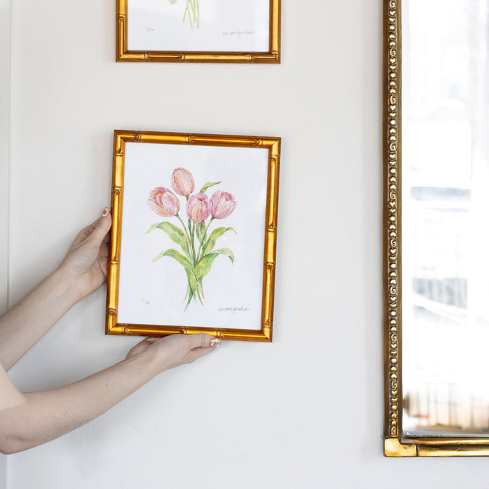 Tulip Archival Art Print — hands holding the framed Tulip study beside separate artwork; Susan Gordon